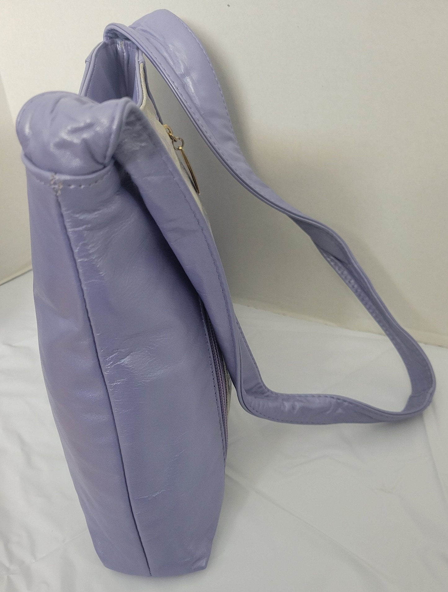Purple with purple Two tone print leather handbag! Two left and right pockets. Made in USA.