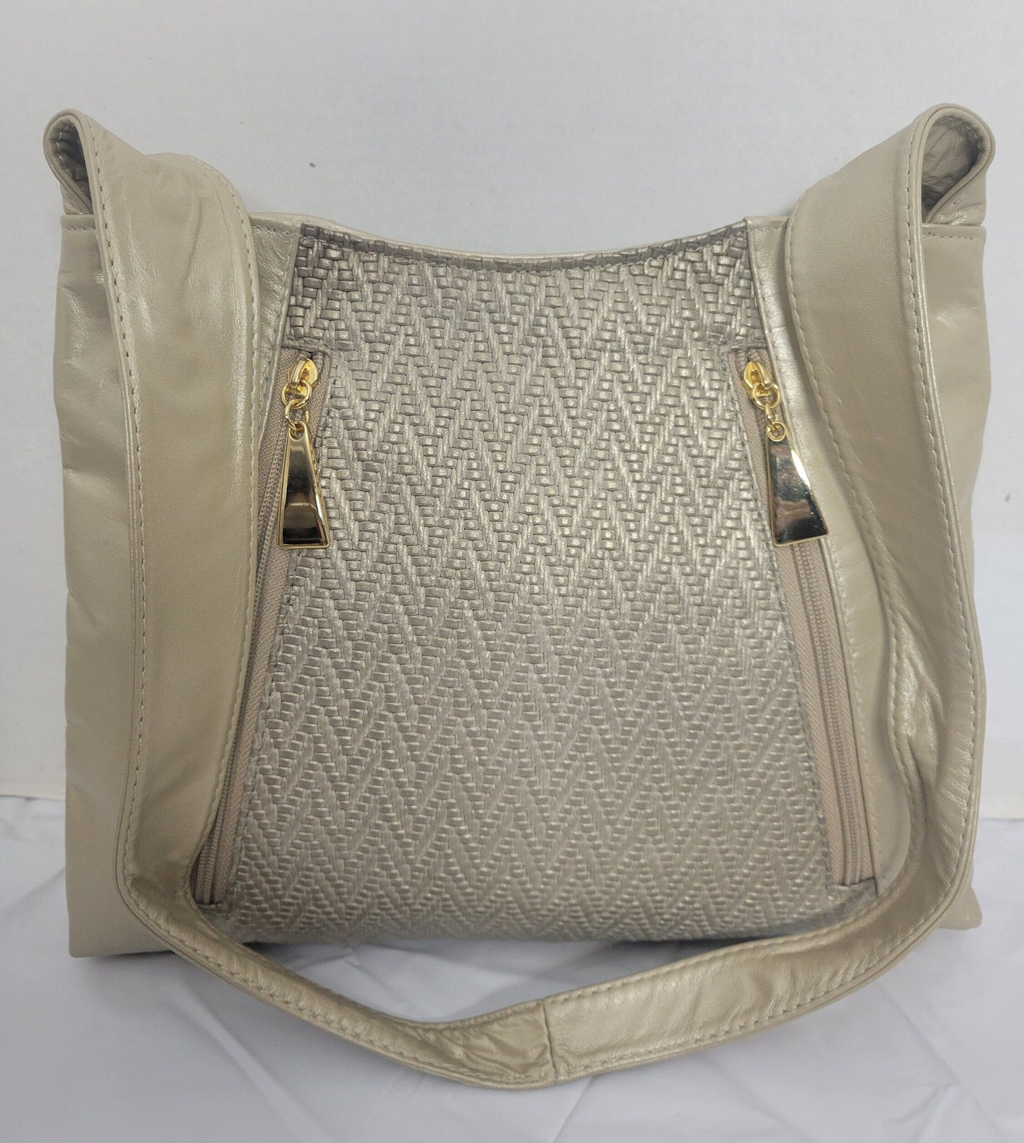 Champagne color with Champagne print leather handbag! Two left and right pockets. Made in USA.