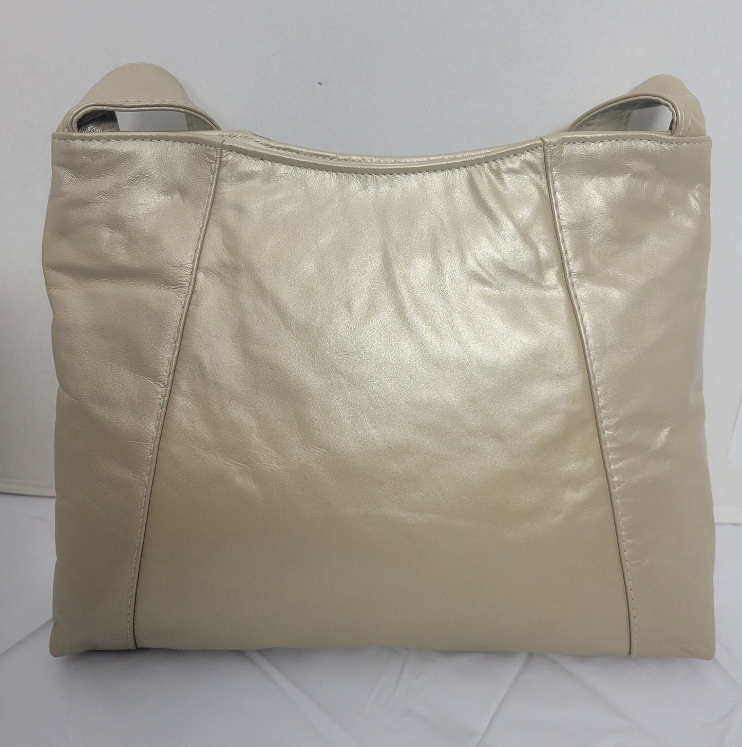 Champagne color with Champagne print leather handbag! Two left and right pockets. Made in USA.