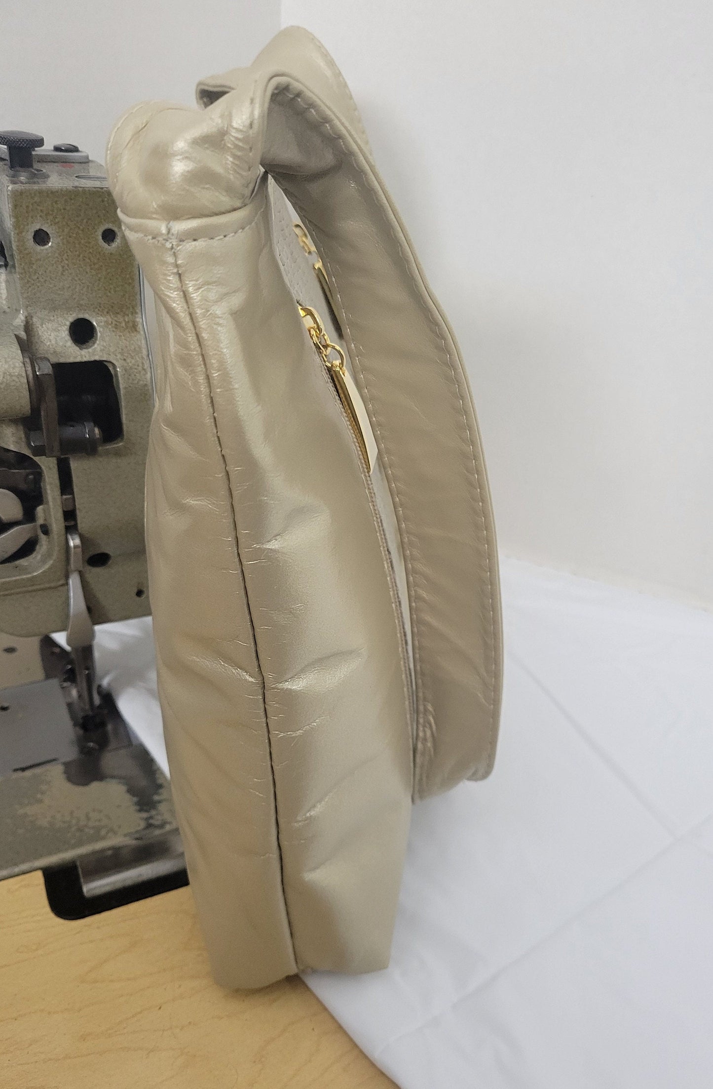 Champagne color with Champagne print leather handbag! Two left and right pockets. Made in USA.