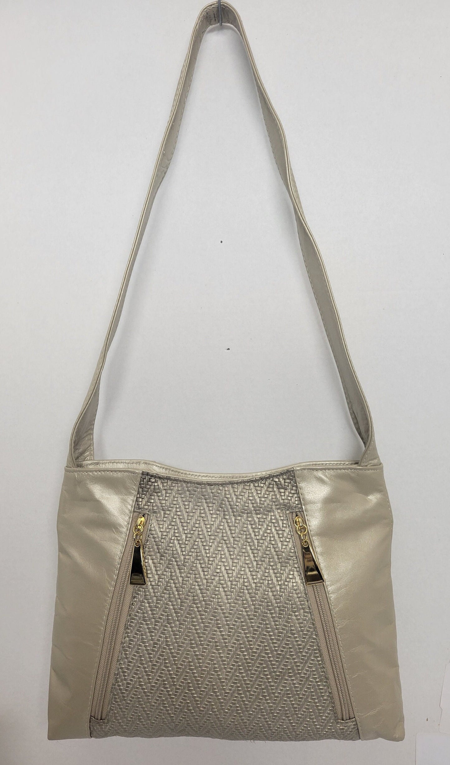 Champagne color with Champagne print leather handbag! Two left and right pockets. Made in USA.