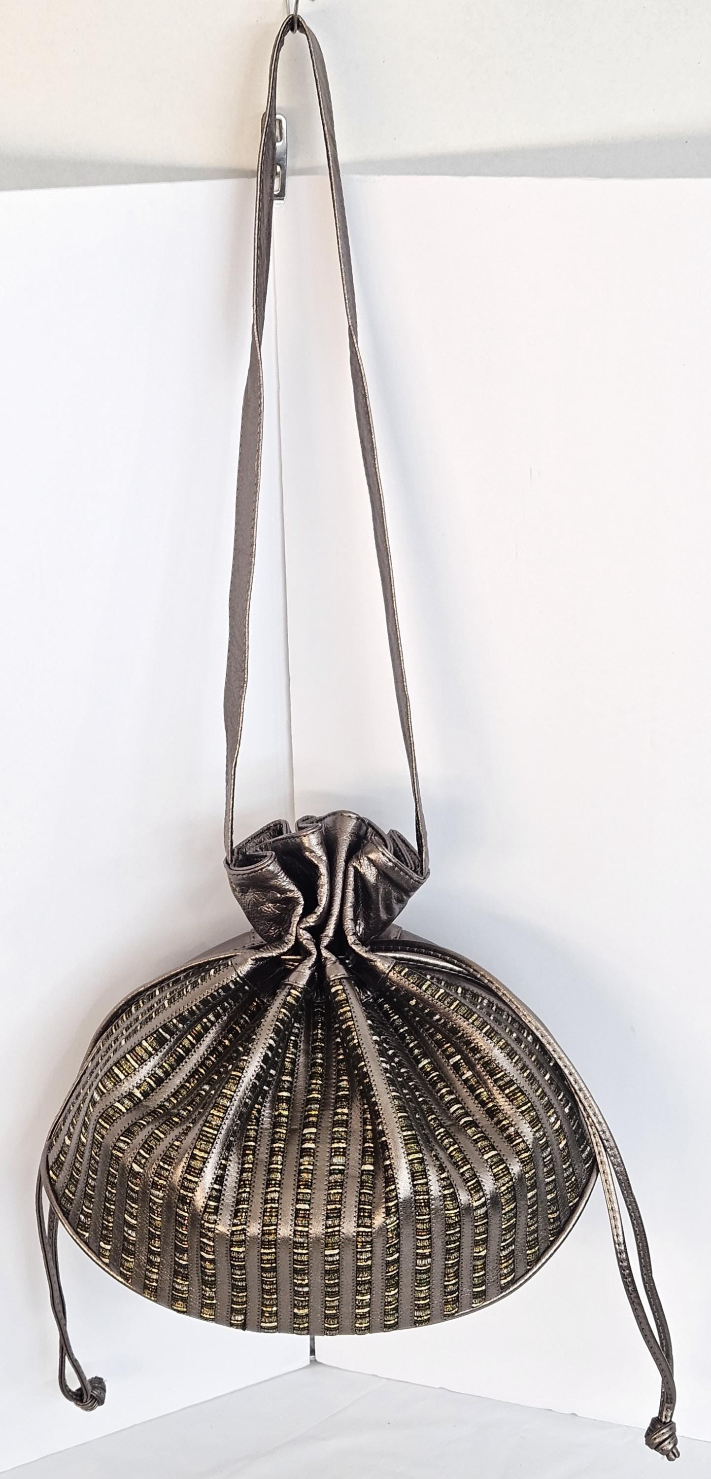 Pewter shinning Genuine Leather with fabric zigzags stripes design. Item TR2031Ps-zig.Close with Drowsting Shoulders.Made in USA.