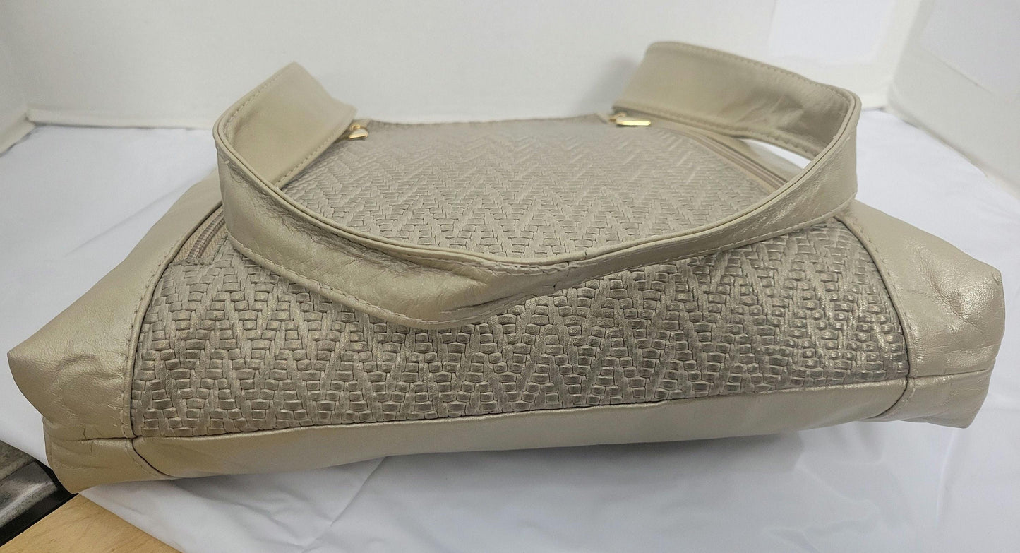 Champagne color with Champagne print leather handbag! Two left and right pockets. Made in USA.