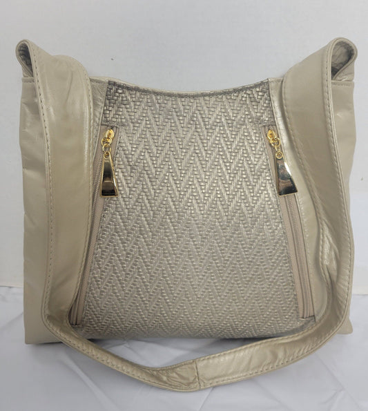 Champagne color with Champagne print leather handbag! Two left and right pockets. Made in USA.