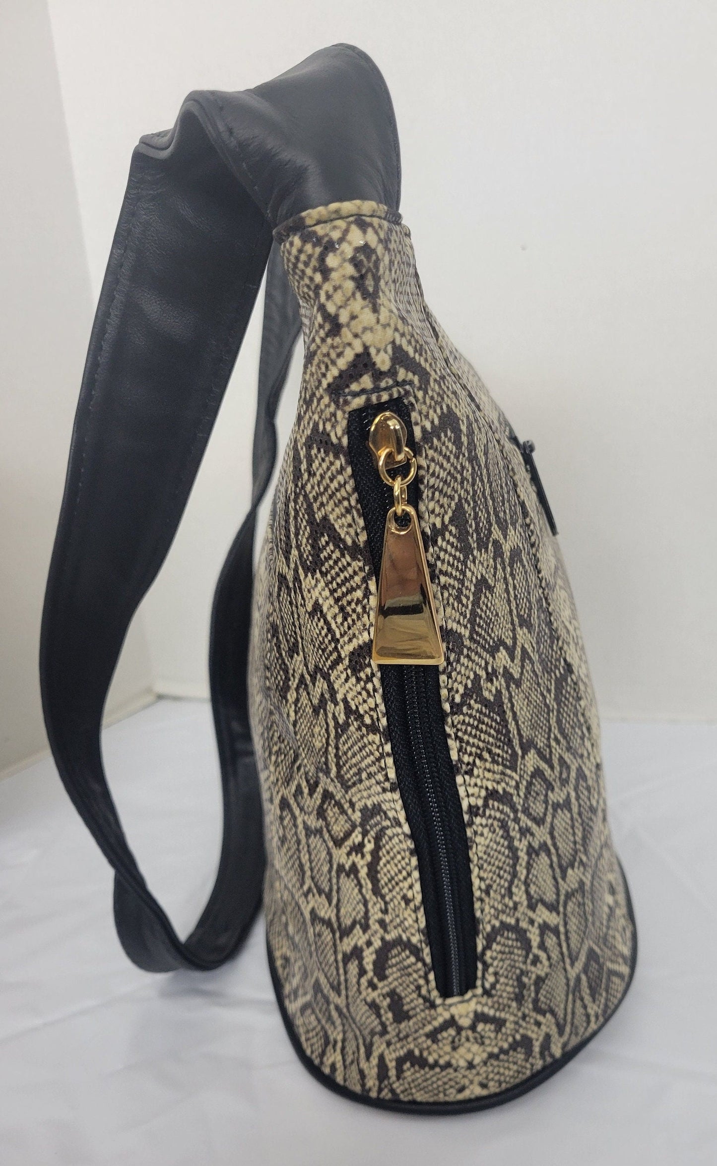 Tejrasila-Black with brown mix snake print fabric with genuine leather Shoulder handbag! Three outside pockets.Made in USA!