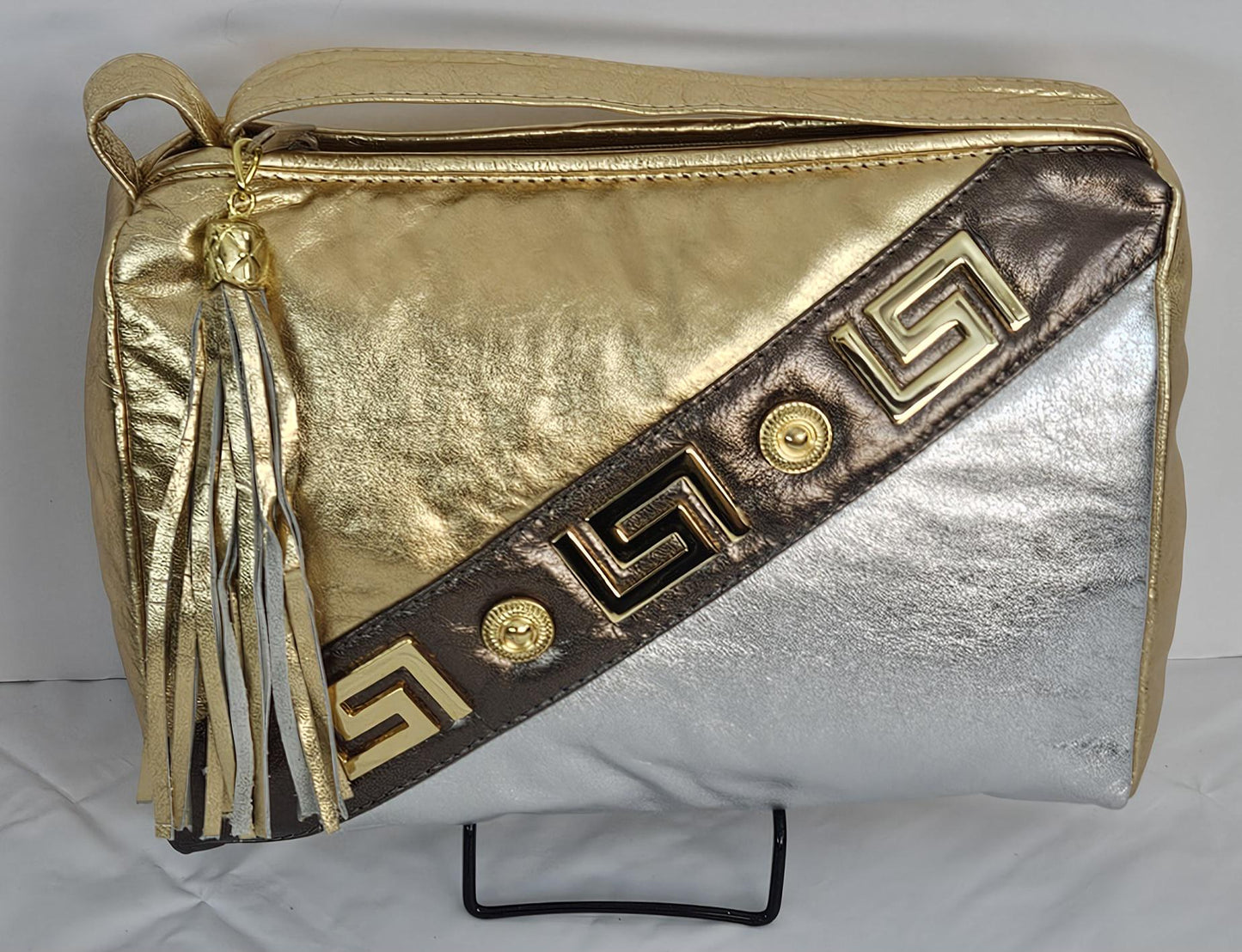 Gold,Silver,and pewter metallic design with gold matel Z&buttons. Genuine Leather Handbag #TR3018GSP-gzb.Made in USA.